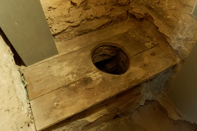 Primitive toilet inside a medieval castle, Piedmont, Italy